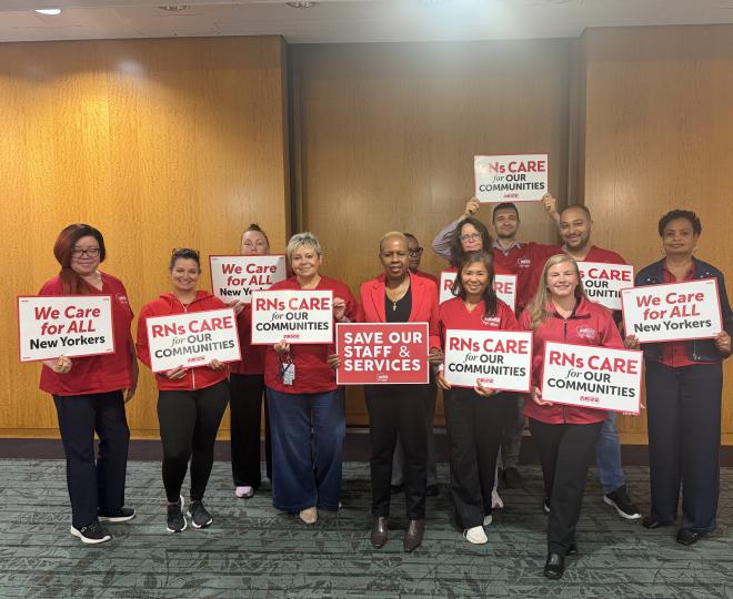 NYSNA nurses pose with signs before attending a PHHPC hearing