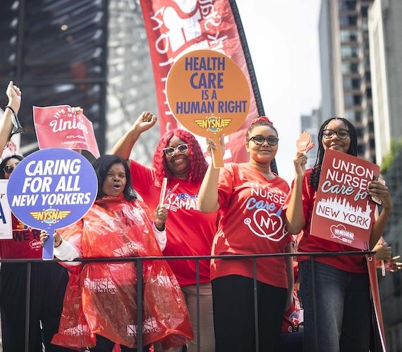 Nurses smiling on float, celebrating Labor Day