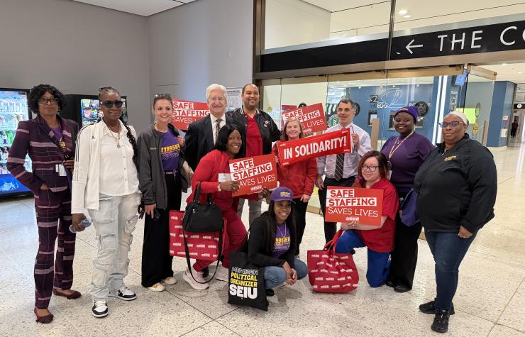 NYSNA members hold signs and pose 