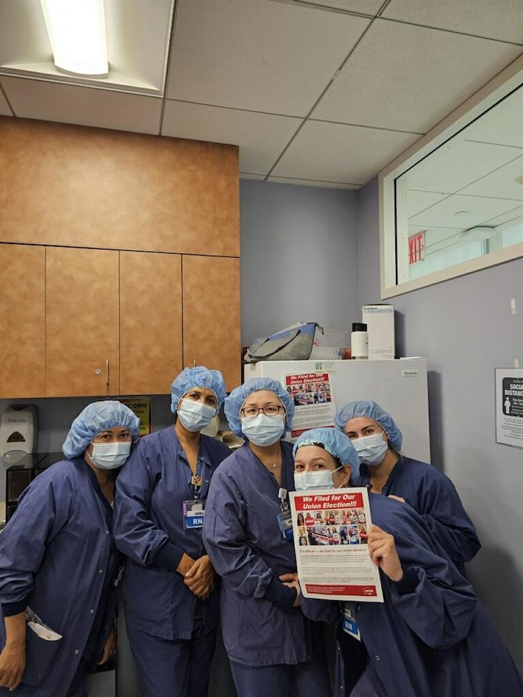 Nurses holding NYSNA signs