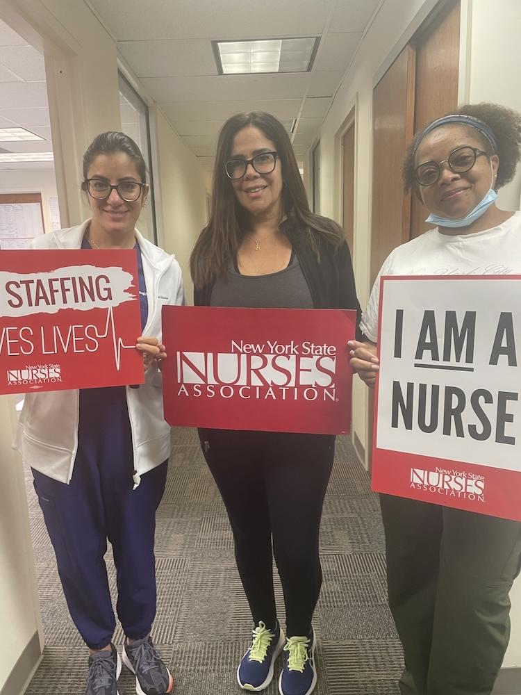 Nurses holding NYSNA signs 
