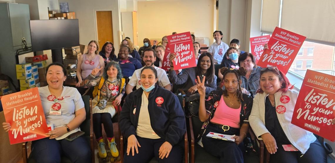 Nurses with signs deliver a petition to hospital management