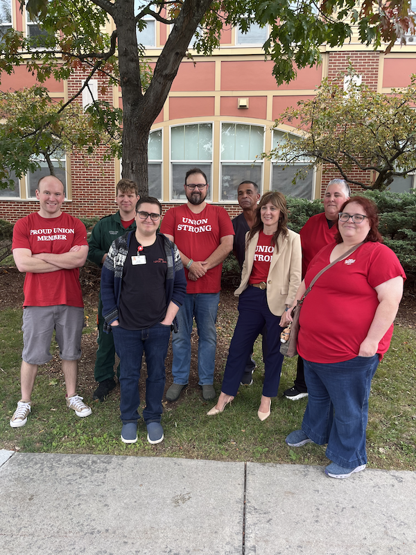 Nurses and healthcare workers pose for a photo after delivering a joint demand letter to the Chairman of UVMH's Board of Trustees