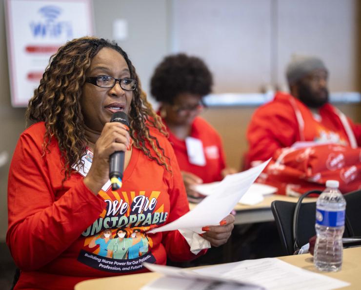 NYSNA nurse speaking into microphone at educational workshop