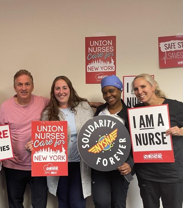 Nurses holding NYSNA signs