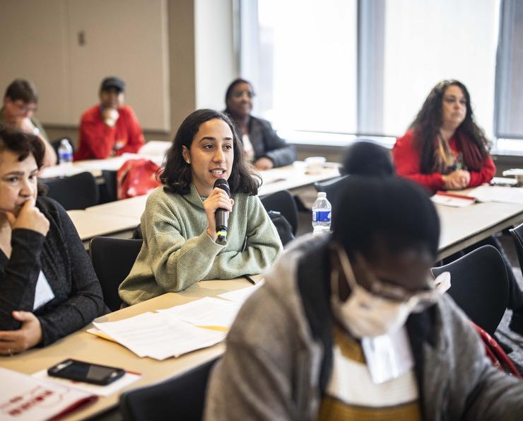 Nurses sitting and speaking at a workshop