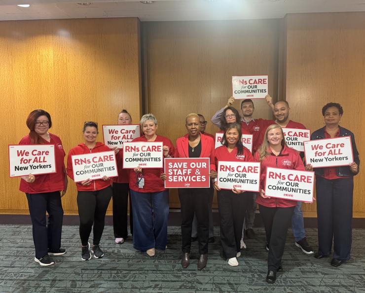 NYSNA nurses pose with signs before attending a PHHPC hearing