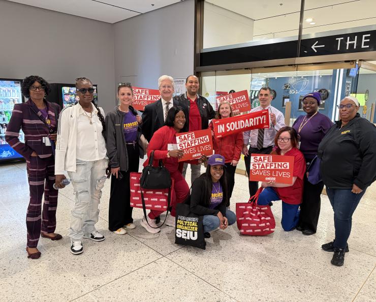 NYSNA members hold signs and pose 