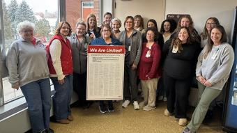 Nurses Pose with a Copy of their Bargaining Platform, After Delivering it to Hospital Management