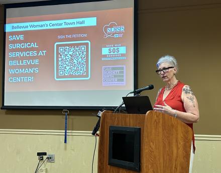 NYSNA member Dawn Zipp, RN, speaks at a town hall about the need to save surgical services at Bellevue Woman's Center