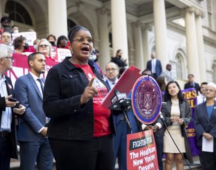 Judith Cutchin, DNP, RN surrounded NYC Council legislators at a rally