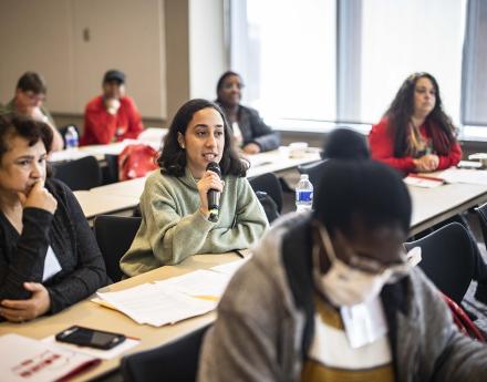 Nurses sitting and speaking at a workshop