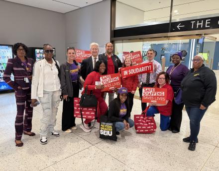 NYSNA members hold signs and pose 