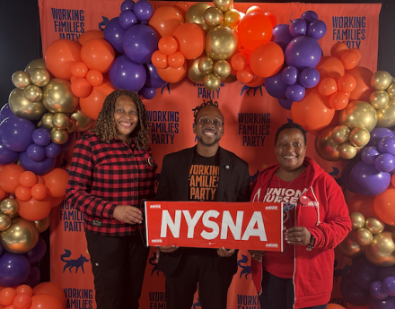 Two nurse leaders pose with a NYSNA sign and a Working Families Party Leader at the 2026 New York Working Families Party Convention
